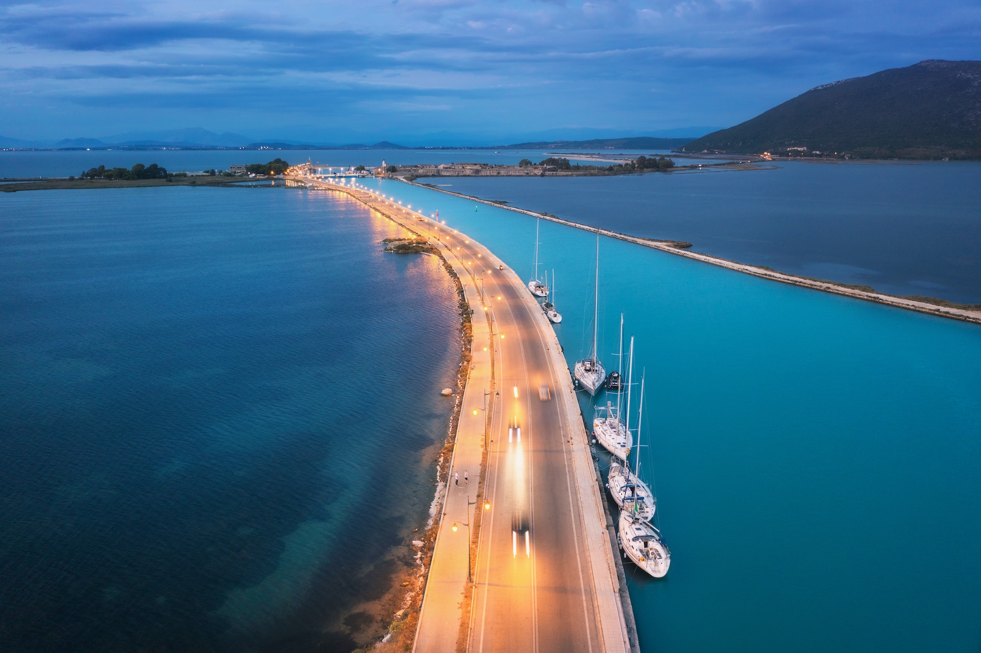 Aerial view of road near sea canal at night in Lefkada, Greece